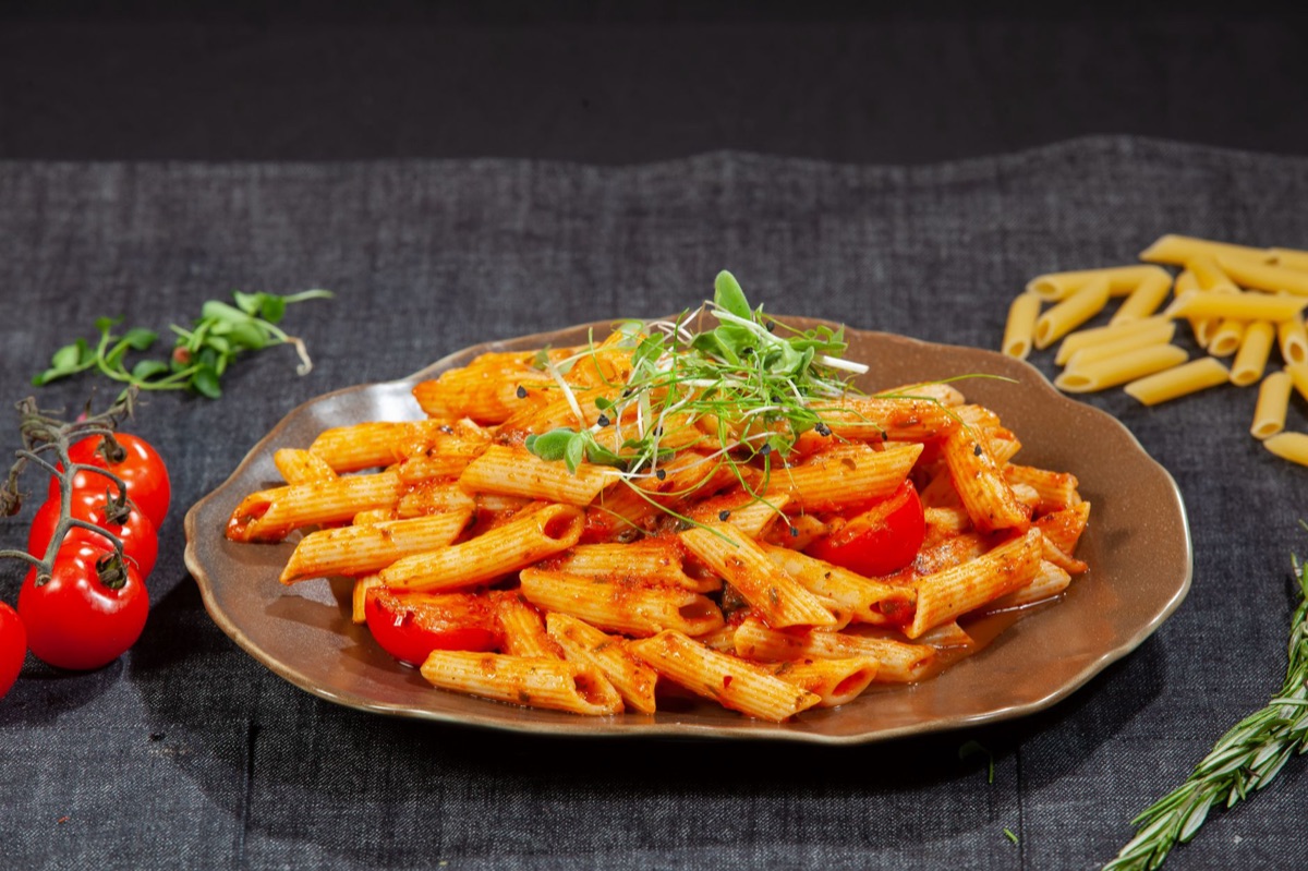 Pasta with tomato sauce and fresh basil.