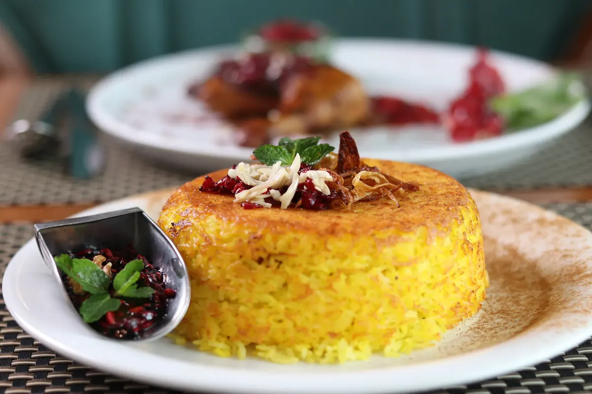 Savor the taste of Persian cuisine with this beautifully plated saffron rice dish, perfect for dinner.