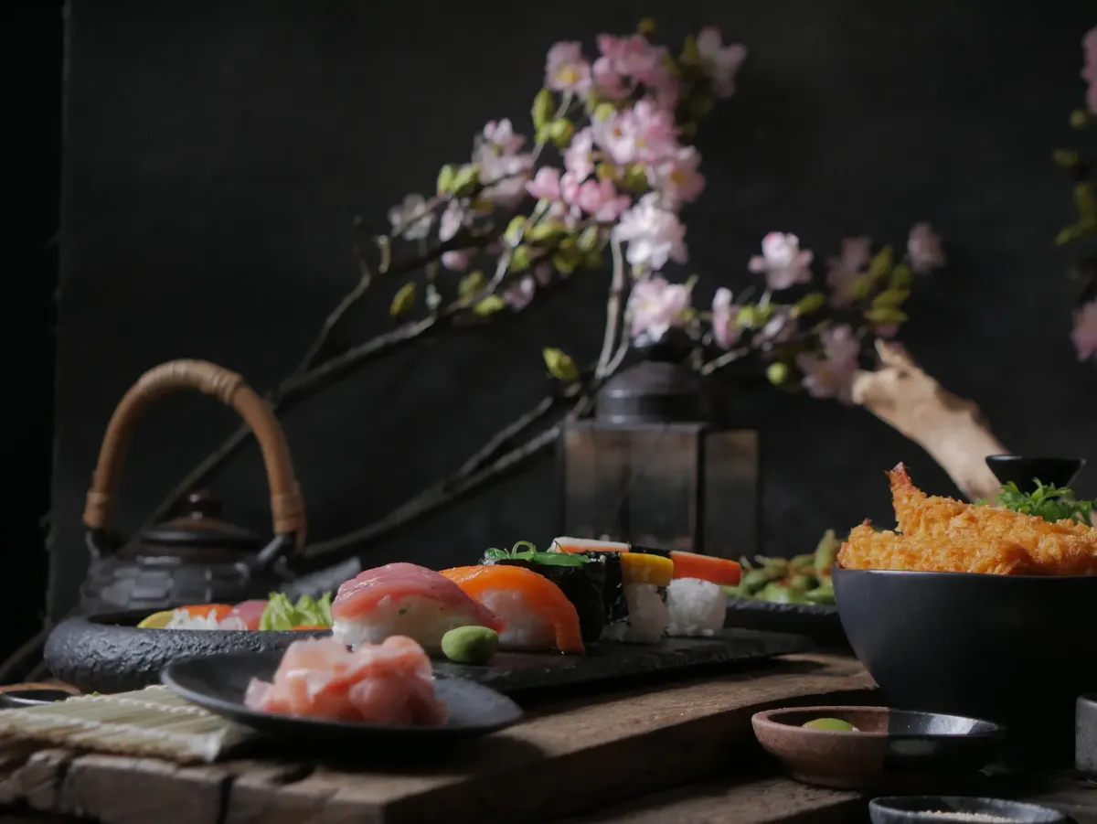 A beautifully arranged sushi platter with cherry blossoms and traditional Japanese theme.