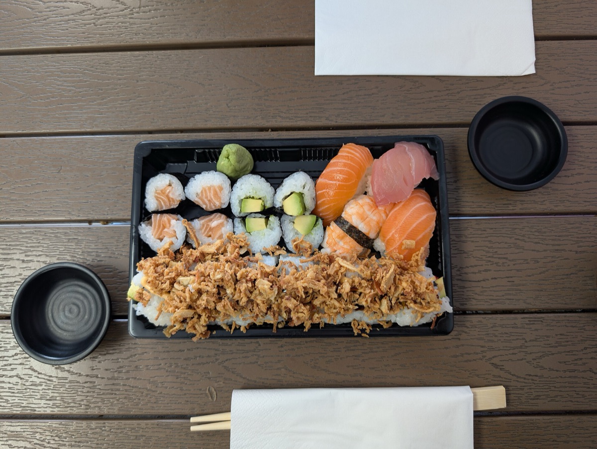 Fresh nigiri sushi with salmon and tuna slices over seasoned rice.